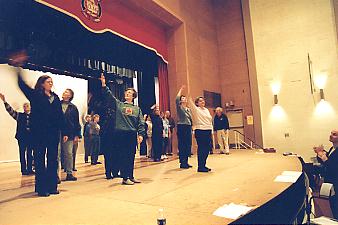 Female chorus rehearses.