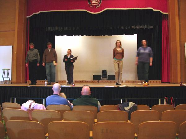 Debbie, Huw, Philip, Heather and Kirsten on stage while Brian and Douglas Tranquada watch from the seats.