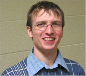 Peter Ballard poses for a head shot in the hallway behind the stage.